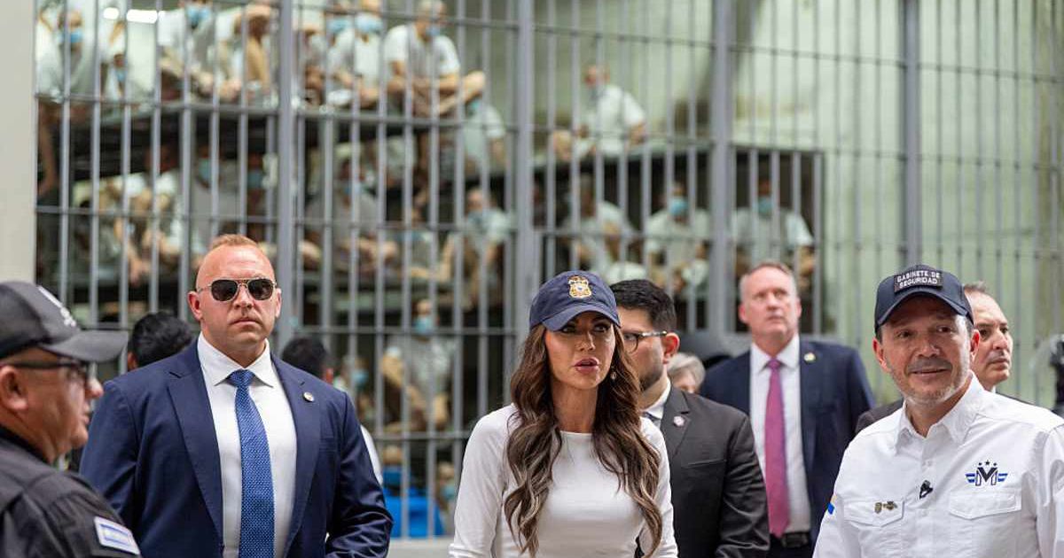 Minister of Justice and Public Security Héctor Villatoro, (R), accompanies Department of Homeland Security Secretary Kristi Noem, (C), during a tour of the Terrorist Confinement Center (CECOT) on March 26, 2025 in Tecoluca, El Salvador. 